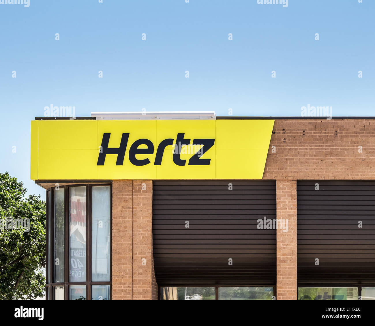 The exterior storefront of a Hertz automobile rental store. Oklahoma City, Oklahoma, USA. Stock Photo