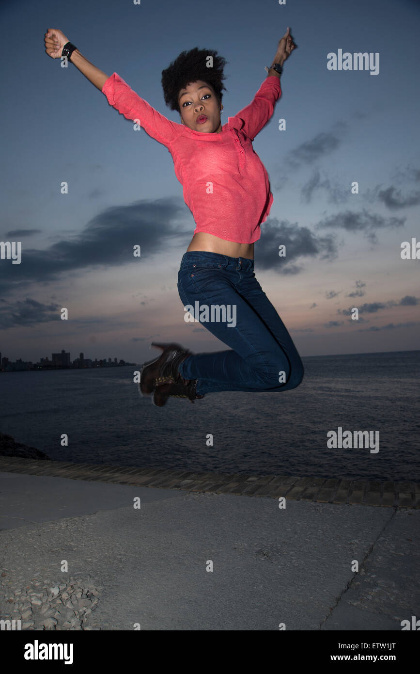 A Latin woman jumping Stock Photo Alamy