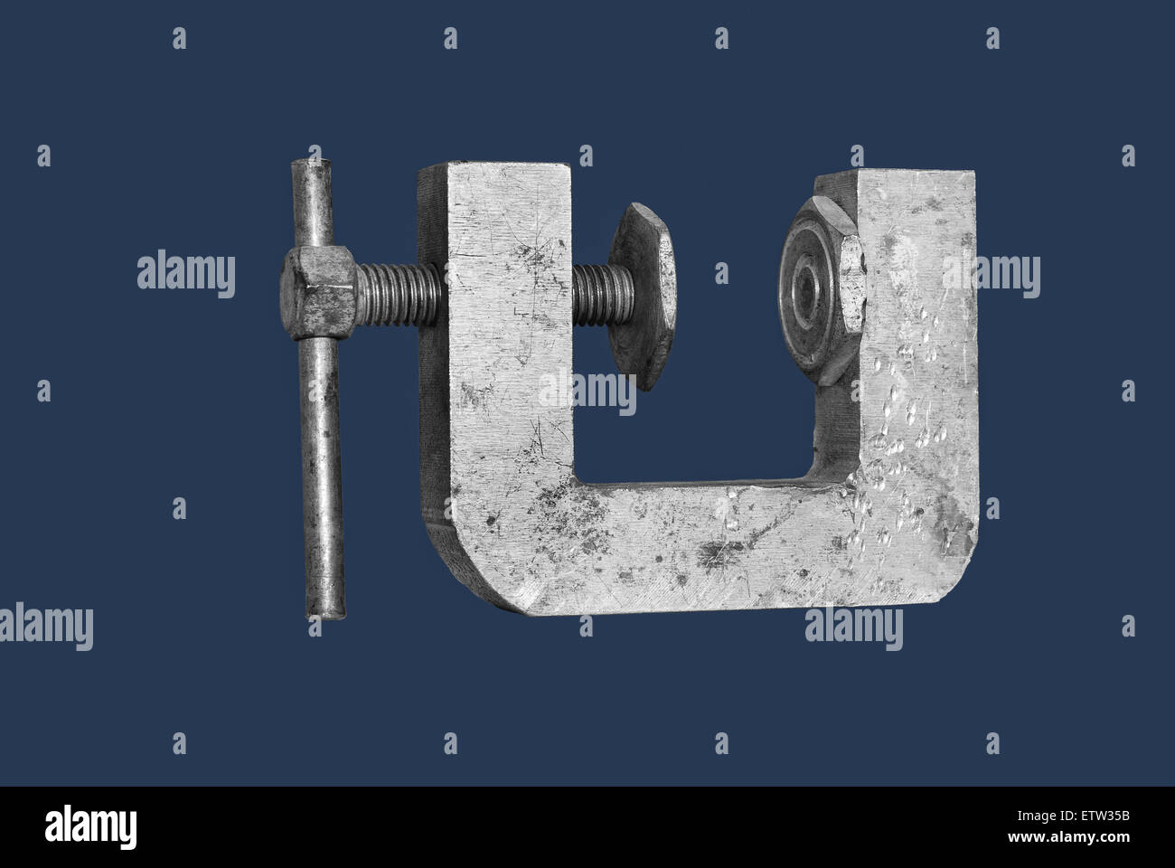 Clamp on a dark blue background. Stock Photo