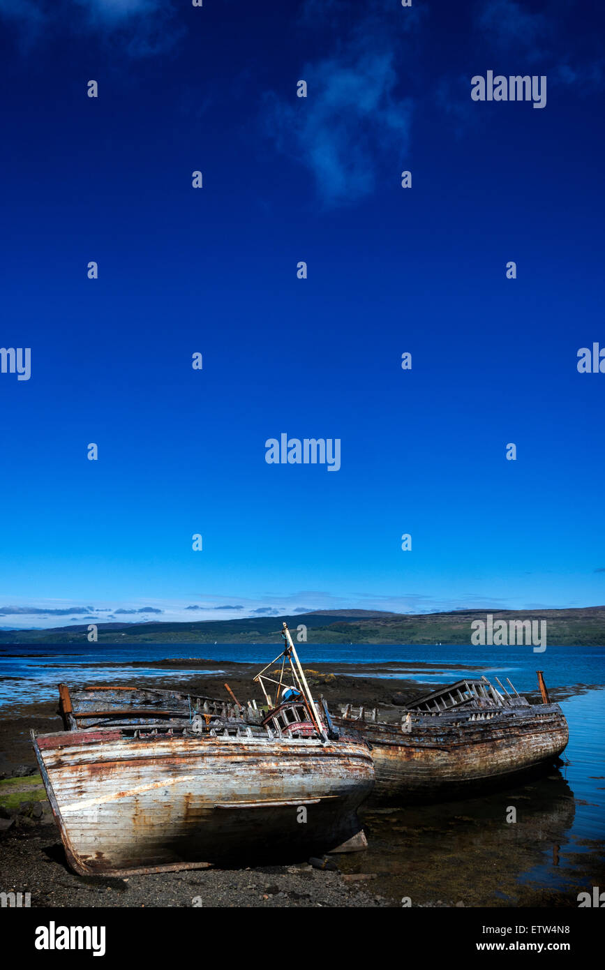 Wrecked fishing boats beached on the shore at Salen, Isle of Mull, Argyll, Inner Hebrides, Scotland. Stock Photo