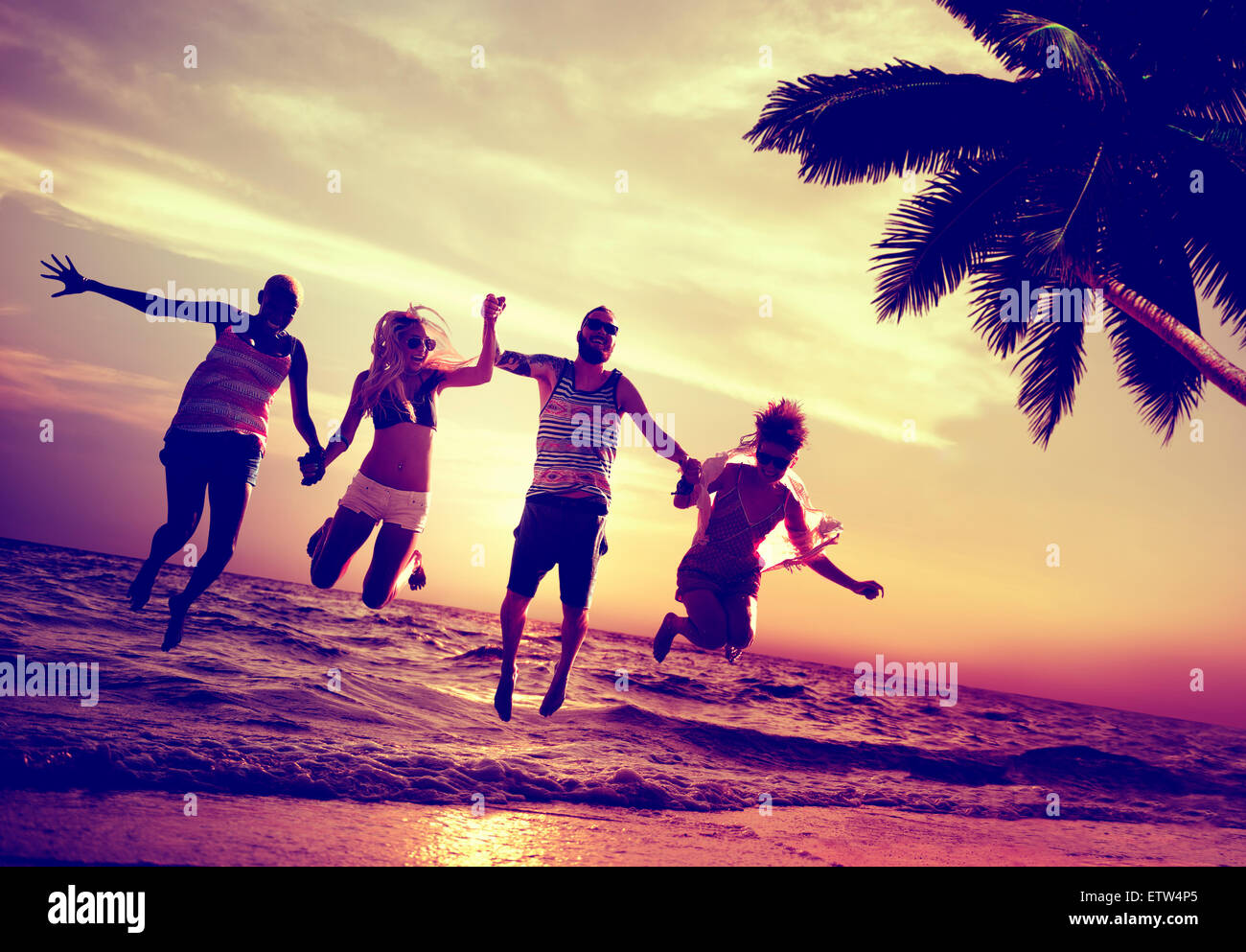 Diverse Beach Summer Friends Fun Jump Shot Concept Stock Photo