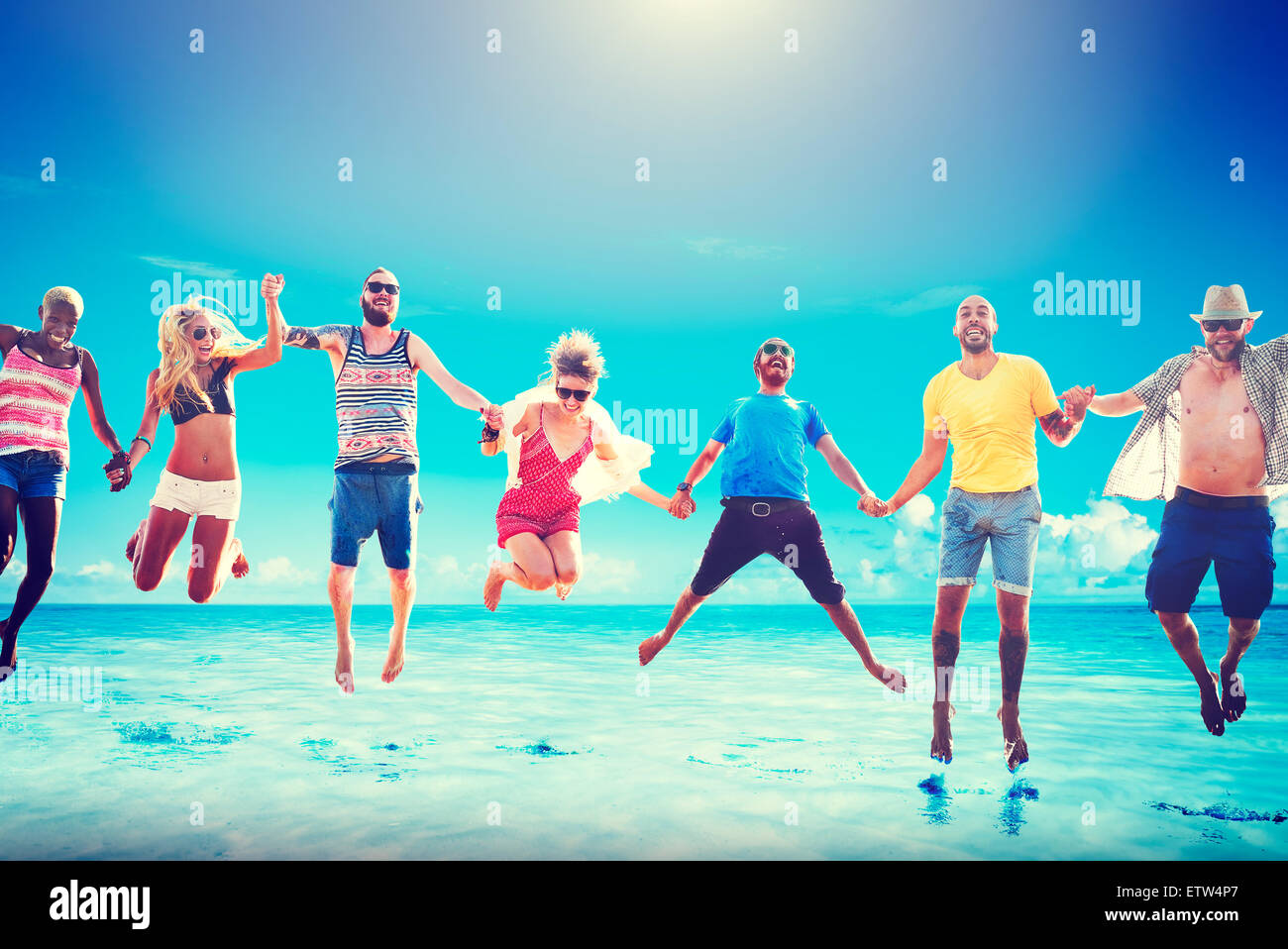 Diverse Beach Summer Friends Fun Jump Shot Concept Stock Photo