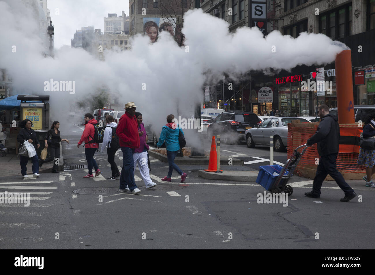 Low clouds of steam are  not an uncommon sight in Manhattan released from under the street. Broadway & 32nd Street. Stock Photo