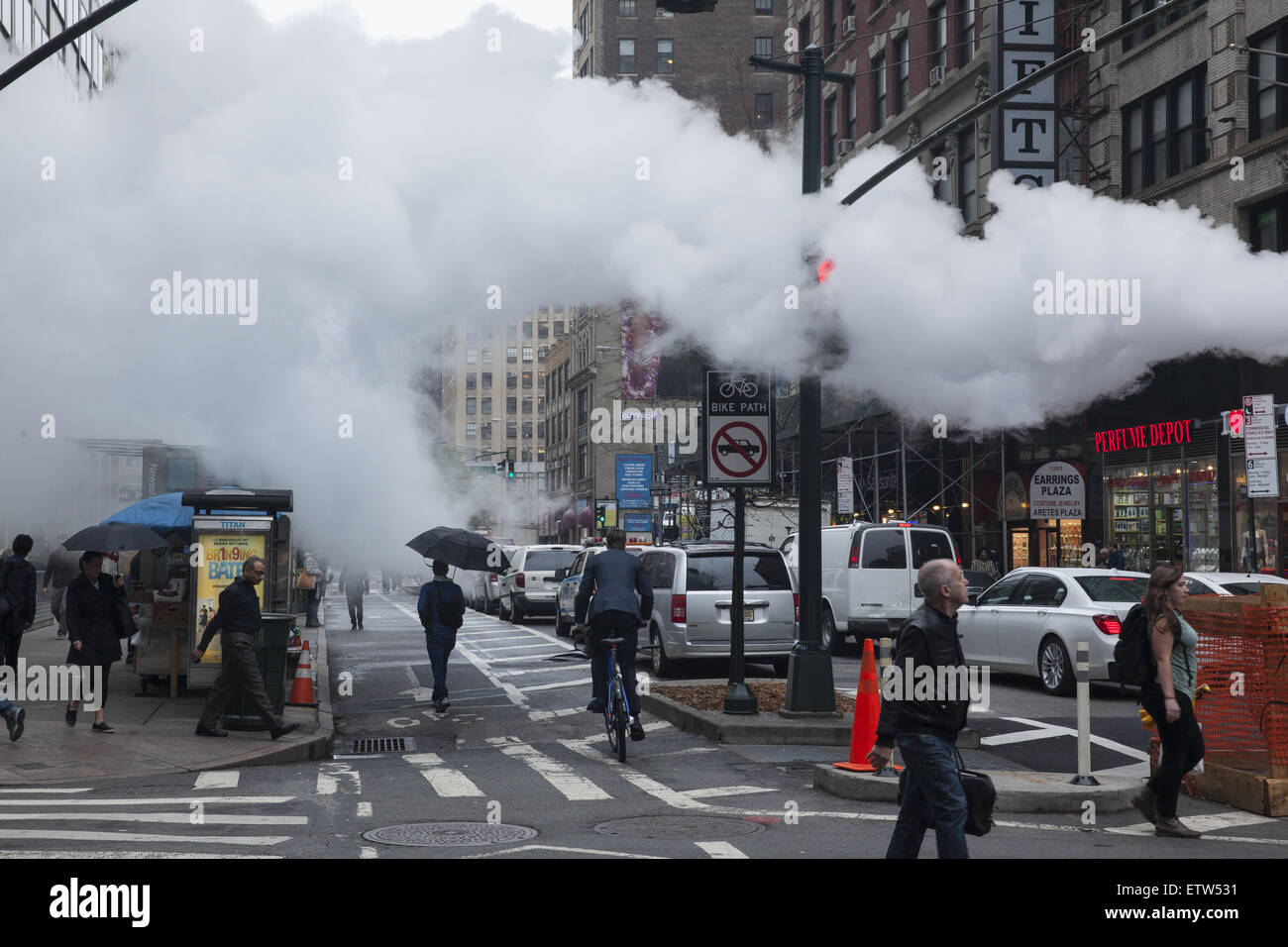 Low clouds of steam are  not an uncommon sight in Manhattan released from under the street. Broadway & 32nd Street. Stock Photo