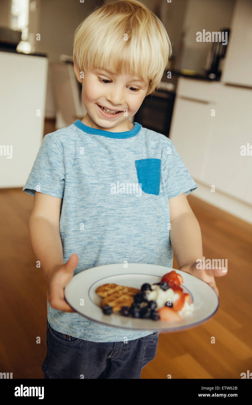 Smiling young boy with plate, waffle Stock Photo