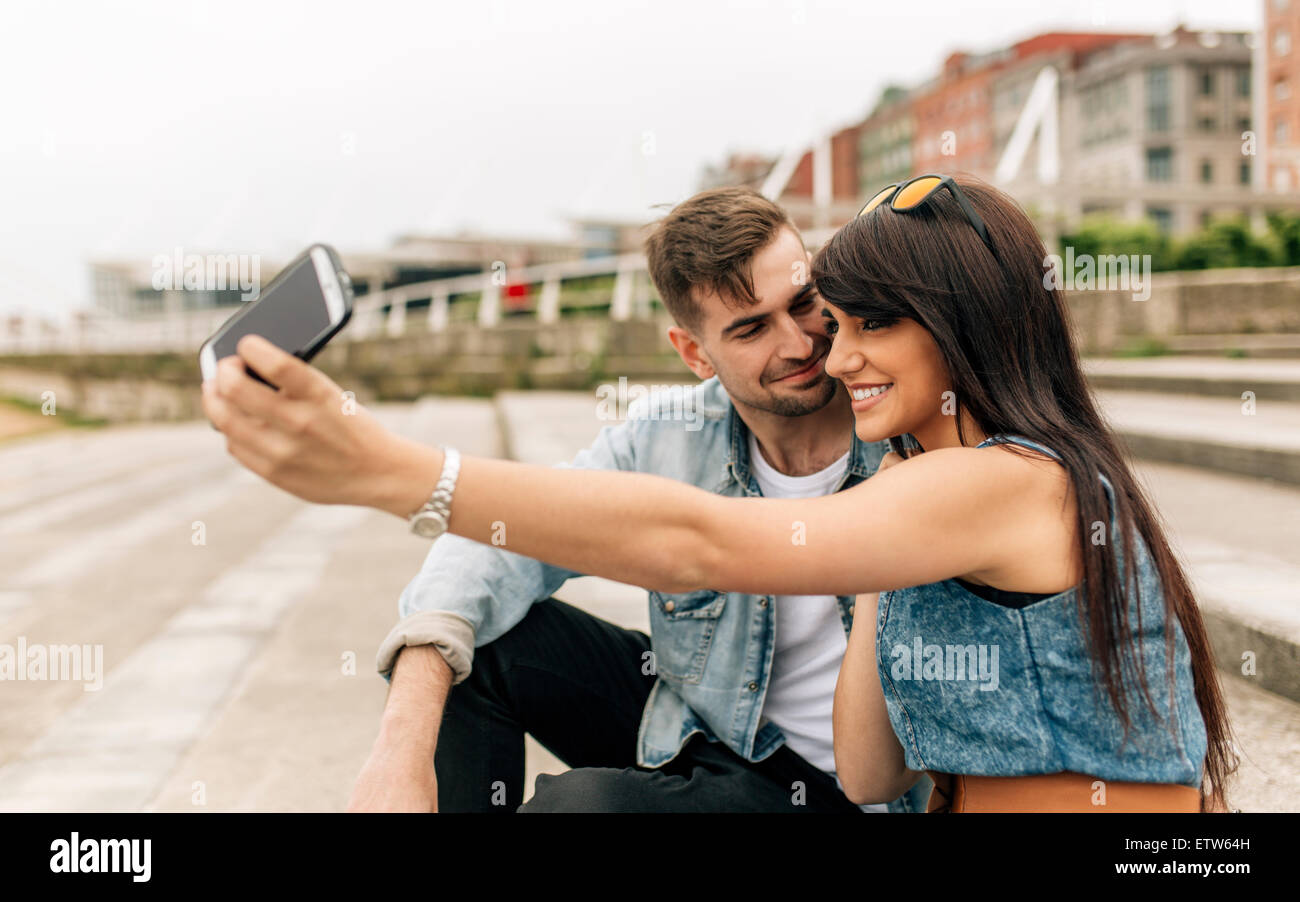 Spain, Gijon, young couple in love taking selfie with smartphone Stock ...