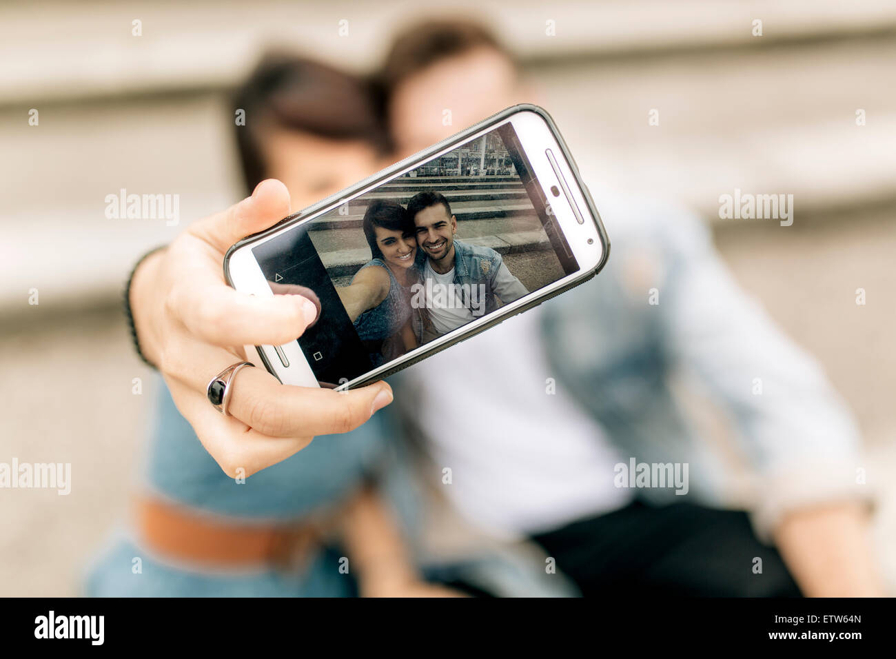 Spain, Gijon, young couple in love taking selfie with smartphone Stock ...