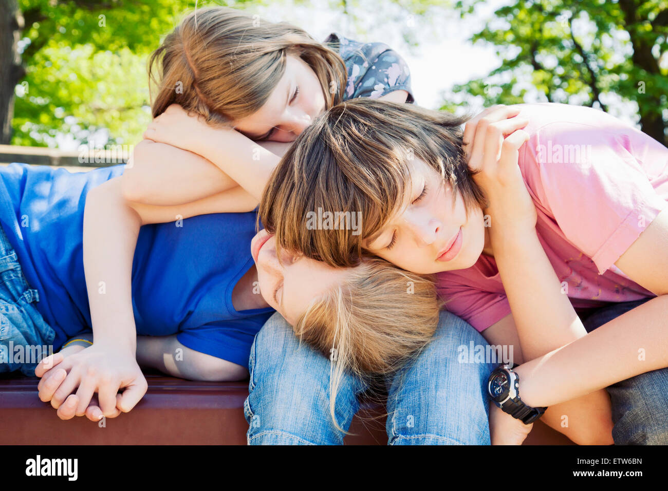 Germany, three children lying one above the other Stock Photo