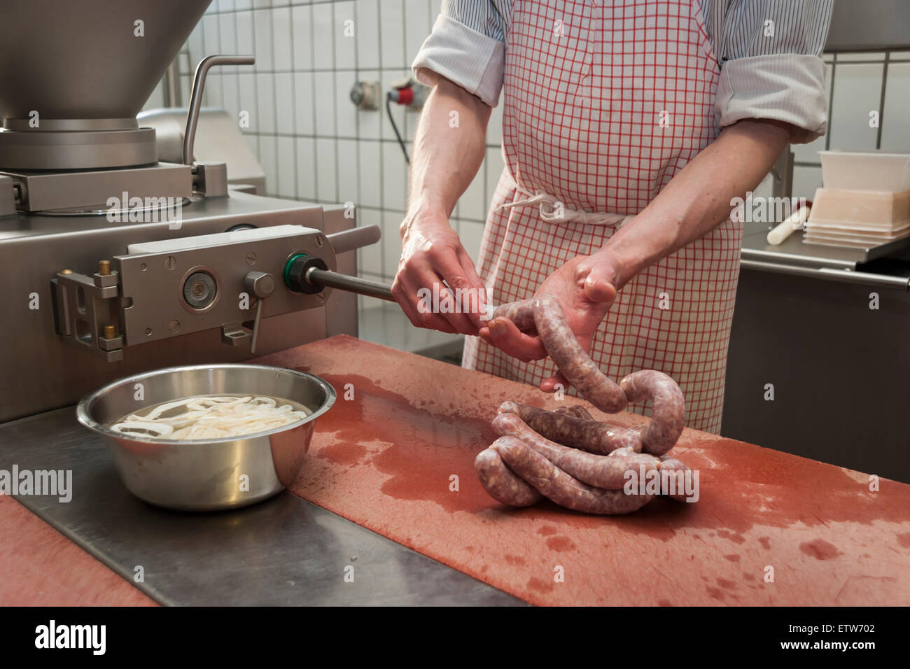 Preparation of smoked sausage, Butcher filling sausage casing Stock