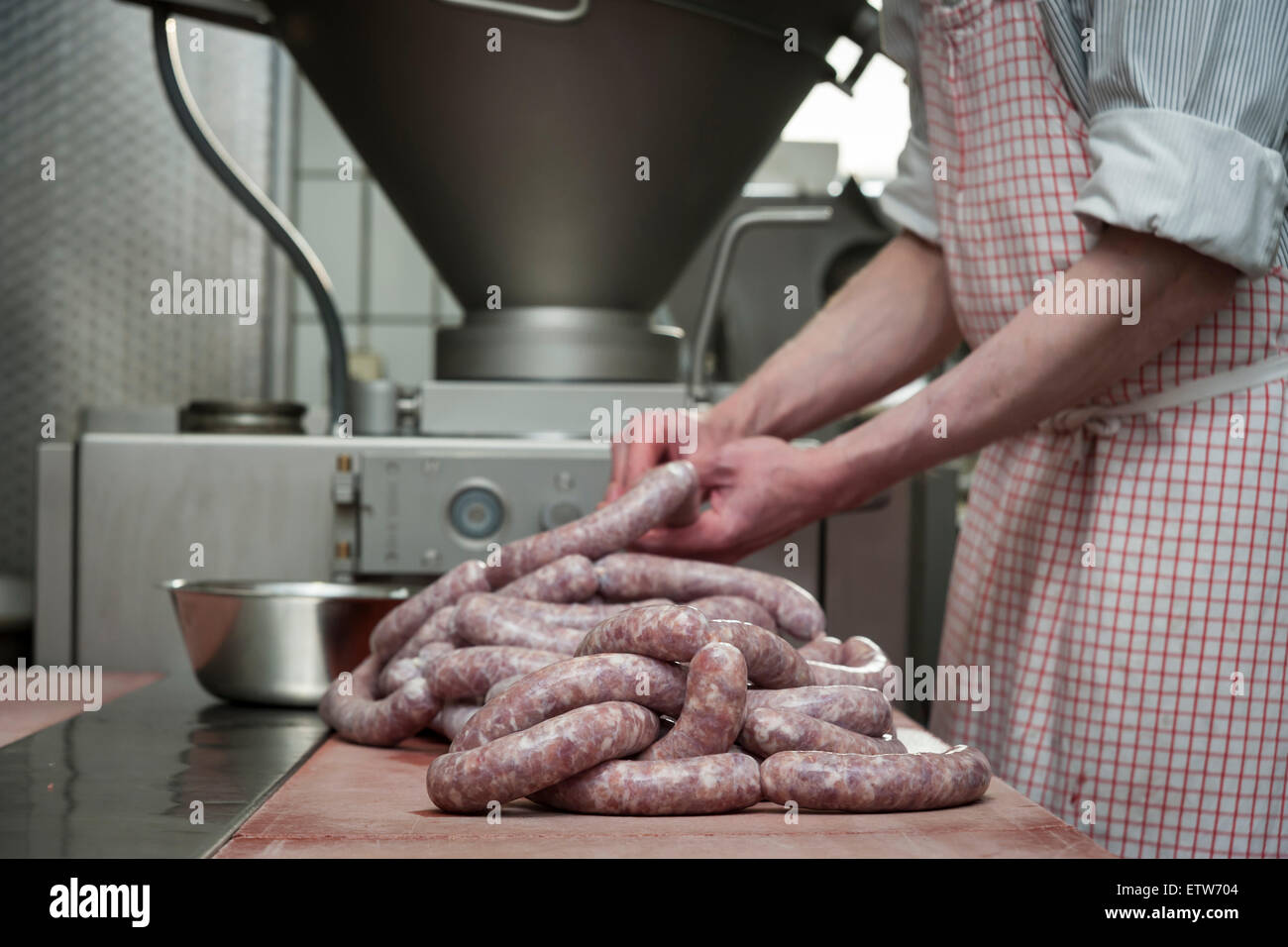 Preparation of smoked sausage, Butcher filling sausage casing Stock