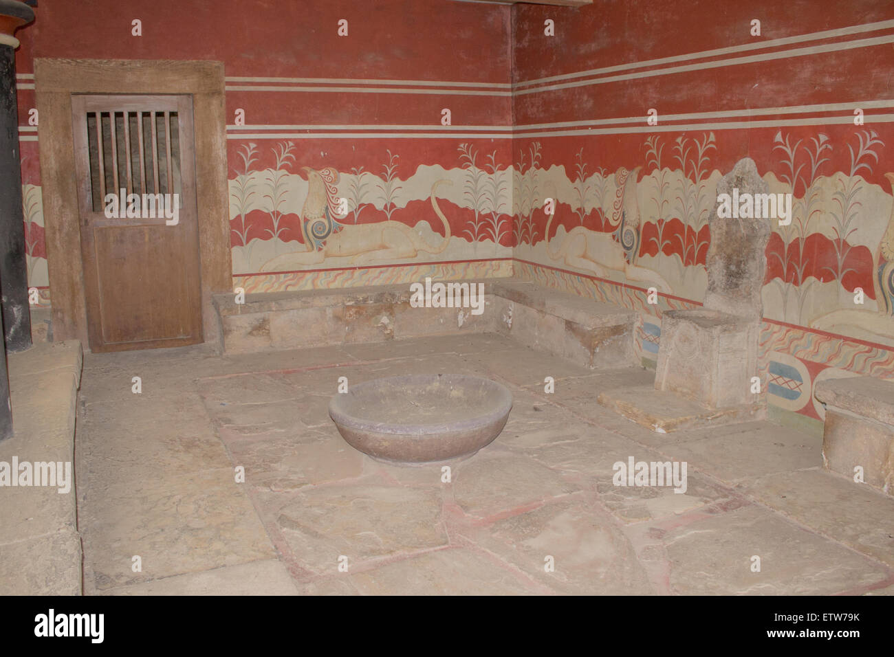 The Throne Room with stone seats and a stone basin that was built for ceremonies at the Knossos Palace, Crete. Stock Photo