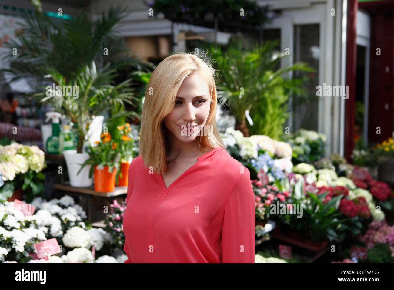 Portrait of smiling blond woman on weekly market Stock Photo