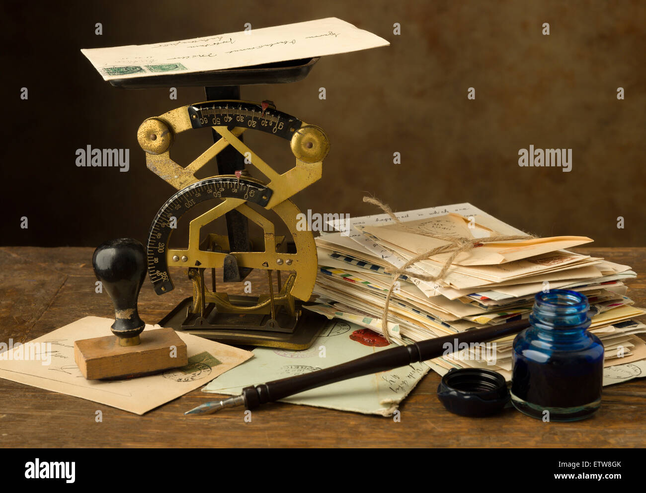 https://c8.alamy.com/comp/ETW8GK/antique-letter-scale-on-an-old-wooden-table-with-a-bundle-of-letters-ETW8GK.jpg