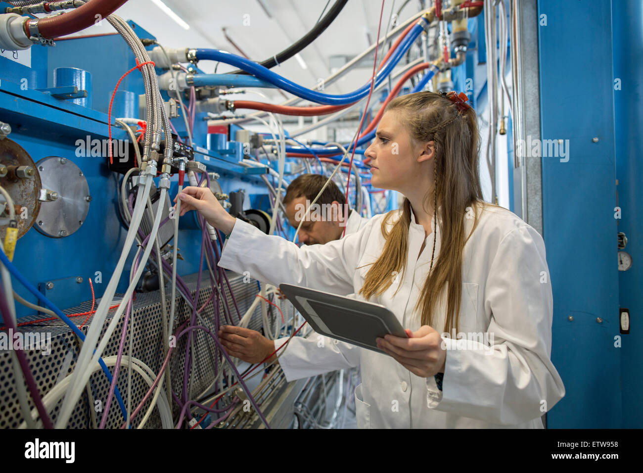 Controlling Machine Two technicians controlling machines Stock Photo - Alamy