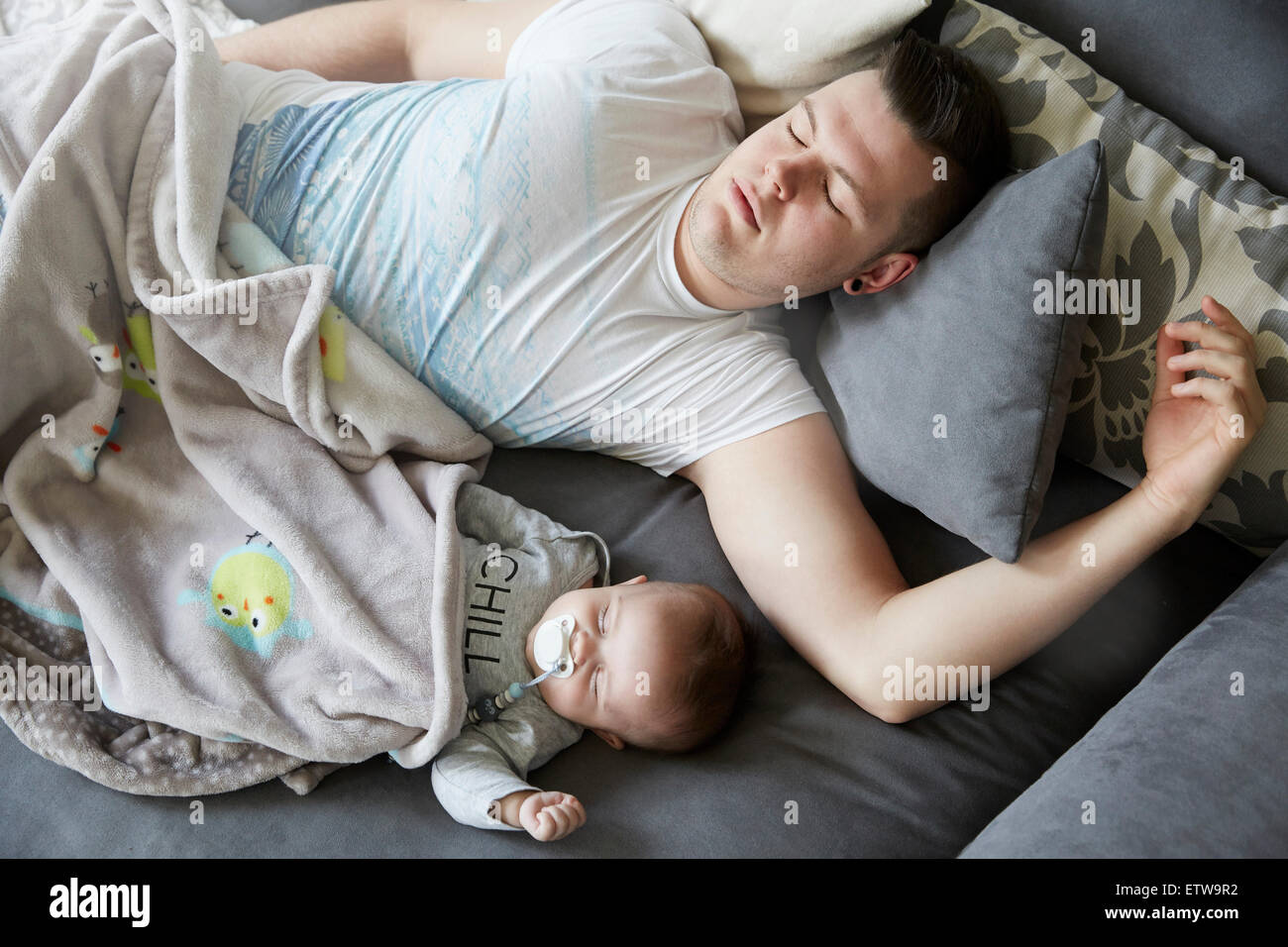 Young father and baby sleeping on couch Stock Photo Alamy