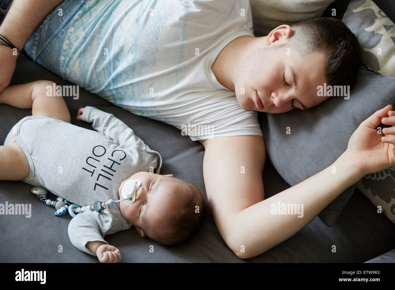 Young father and baby sleeping on couch Stock Photo Alamy