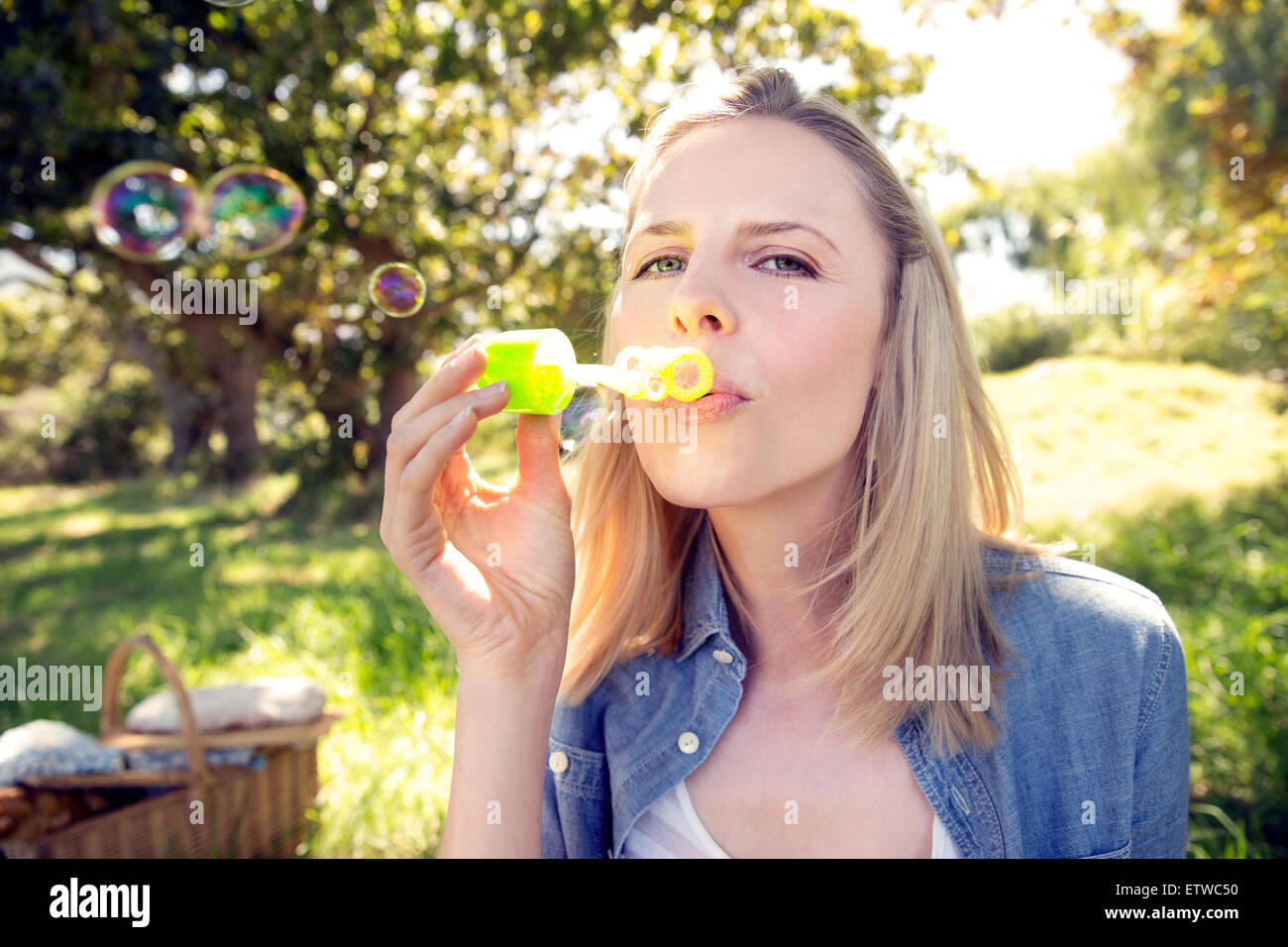Woman blowing soap bubbles Stock Photo - Alamy