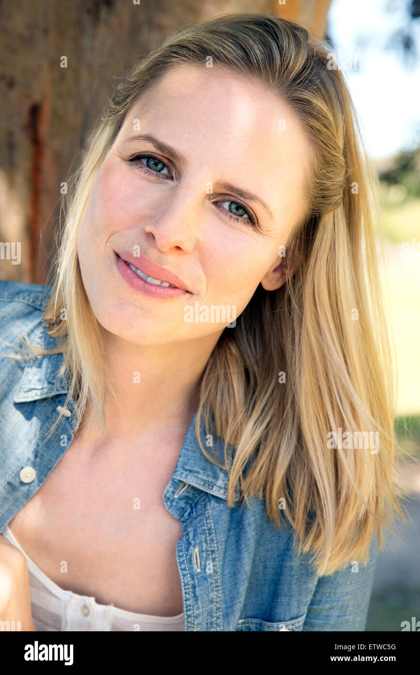 Portrait of smiling blond woman outdoors Stock Photo - Alamy