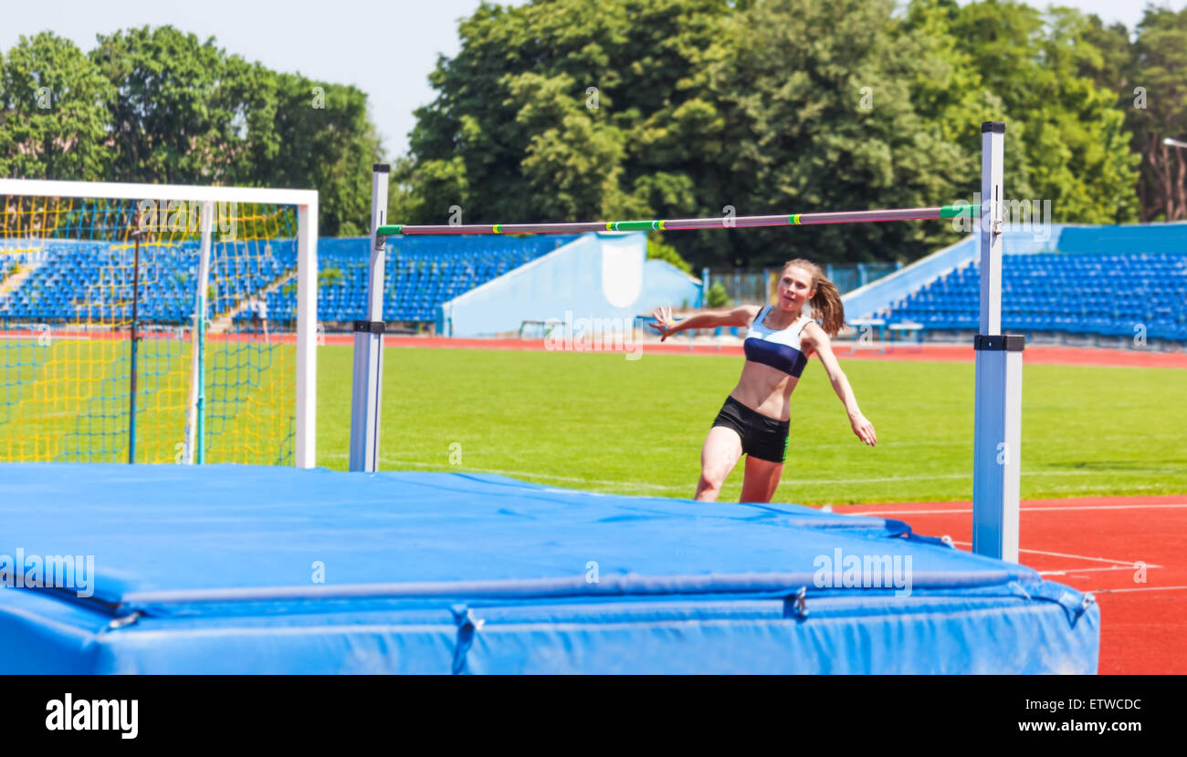 female in athletics competitions on high jump Stock Photo