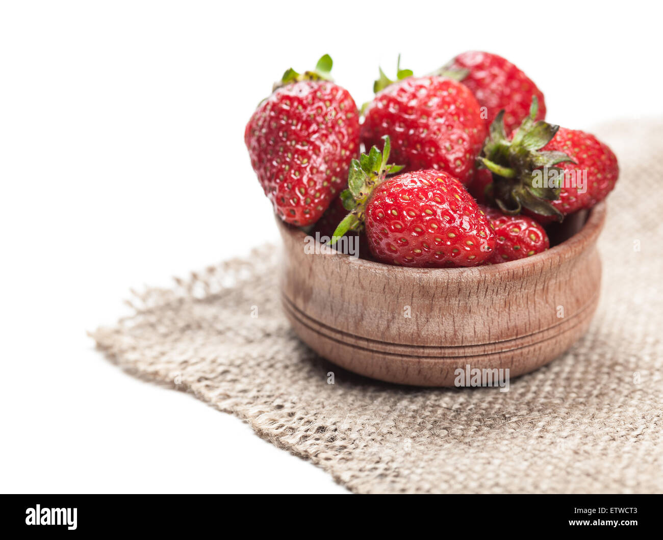 ripe strawberry in wooden bowl on a white background Stock Photo - Alamy