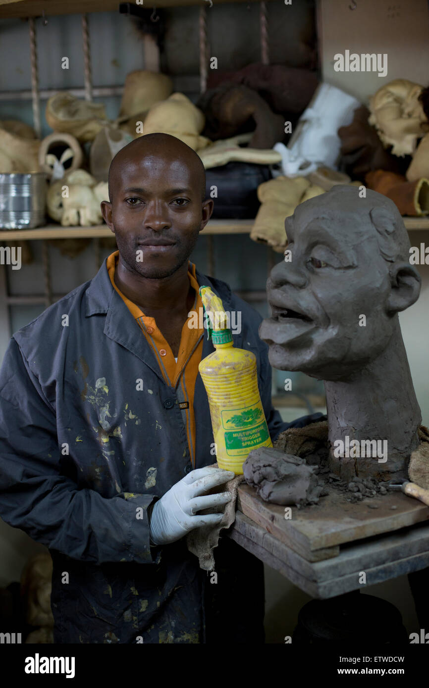 Puppet maker Im Muchemi pose with a clay mould of a puppet at the GoDown Arts Centre , 26 February 2013 where the satirical television program, The XYZ Show is produced. A satirical television program, The XYZ Show comments on current political and social affairs in Kenya through the use of latex puppets resembling prominent figures.On The XYZ Show, national leaders in Kenya are lampooned with the purpose of using humour to address difficult and controversial national issues while promoting transparency in government.  The XYZ Show is modelled after the UKÕs ÒSpitting ImageÓ and FranceÕs ÒLes  Stock Photo