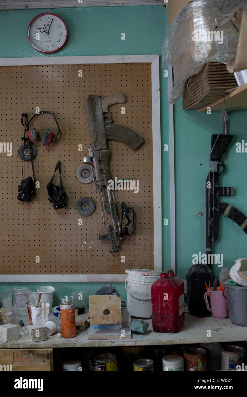 Various props of guns hangs in the workshop at the GoDown Arts Centre , 26 February 2013 where the satirical television program, The XYZ Show is produced. A satirical television program, The XYZ Show comments on current political and social affairs in Kenya through the use of latex puppets resembling prominent figures.On The XYZ Show, national leaders in Kenya are lampooned with the purpose of using humour to address difficult and controversial national issues while promoting transparency in government.  The XYZ Show is modelled after the UKÕs ÒSpitting ImageÓ and FranceÕs ÒLes Guignols de LÕI Stock Photo