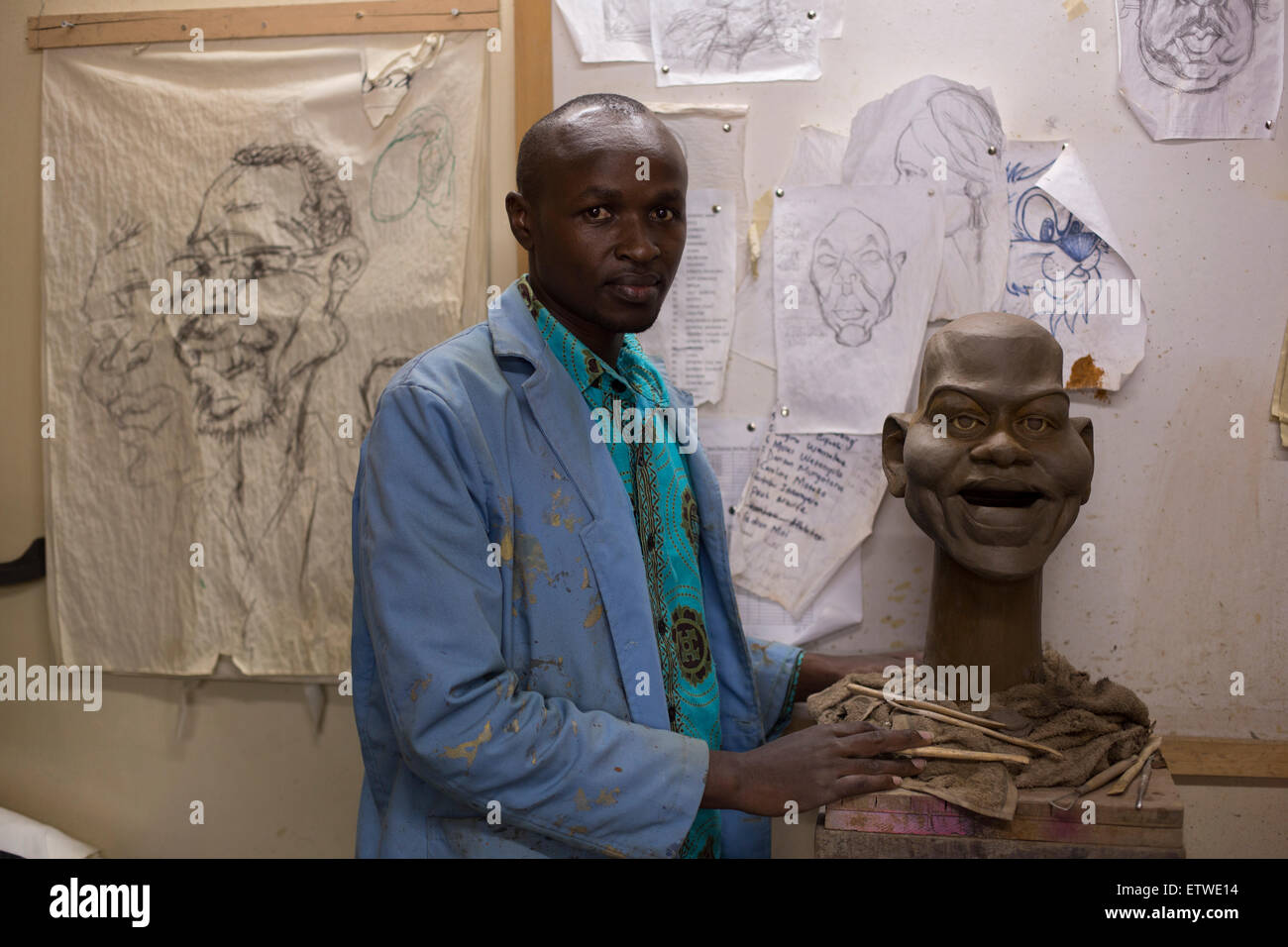 Sculptor Eric Mokua pose with a clay model of US First Lady Michelle Obama at the GoDown Arts Centre , 26 February 2013 where the satirical television program, The XYZ Show is produced. A satirical television program, The XYZ Show comments on current political and social affairs in Kenya through the use of latex puppets resembling prominent figures.On The XYZ Show, national leaders in Kenya are lampooned with the purpose of using humour to address difficult and controversial national issues while promoting transparency in government.  The XYZ Show is modelled after the UKÕs ÒSpitting ImageÓ an Stock Photo