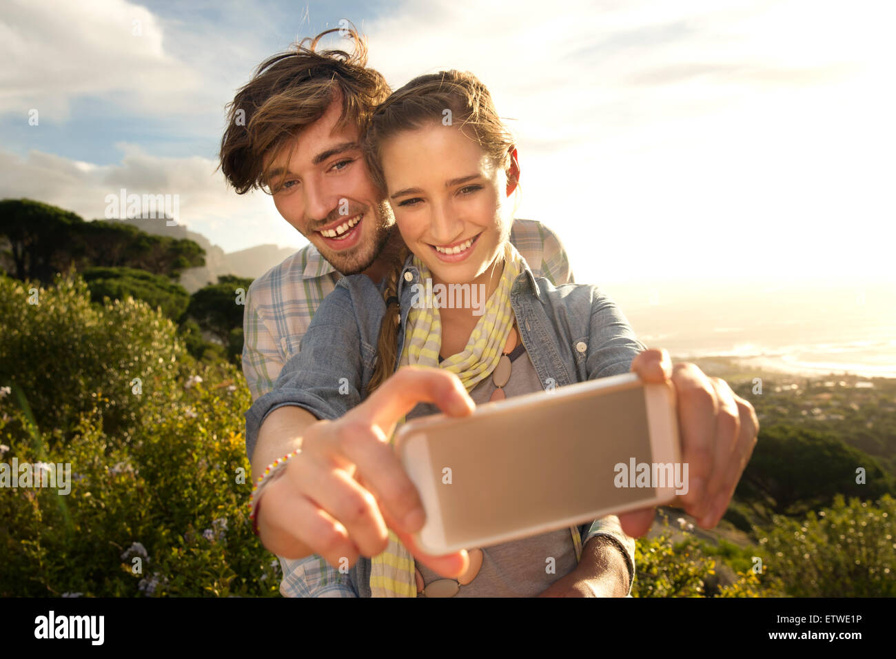 Happy young couple taking a selfie at the coast Stock Photo - Alamy