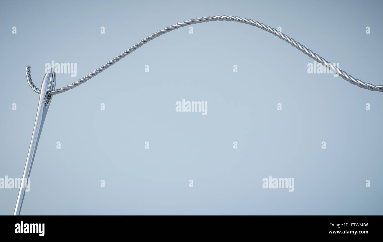 Threading steel cable in needle eye Stock Photo Alamy