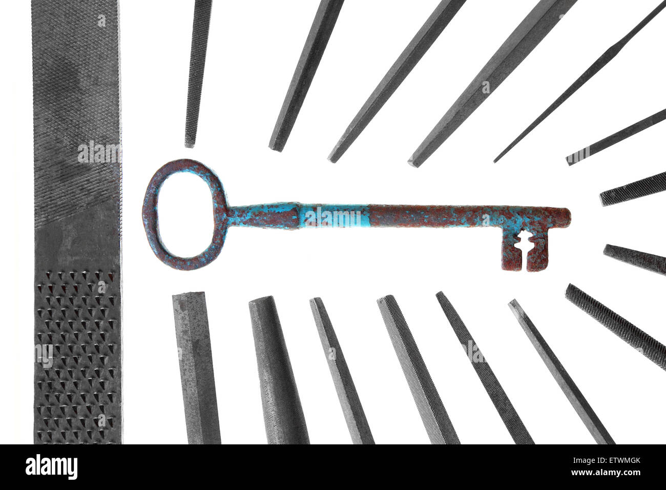 group of vintage metal files teamwork making big key on white