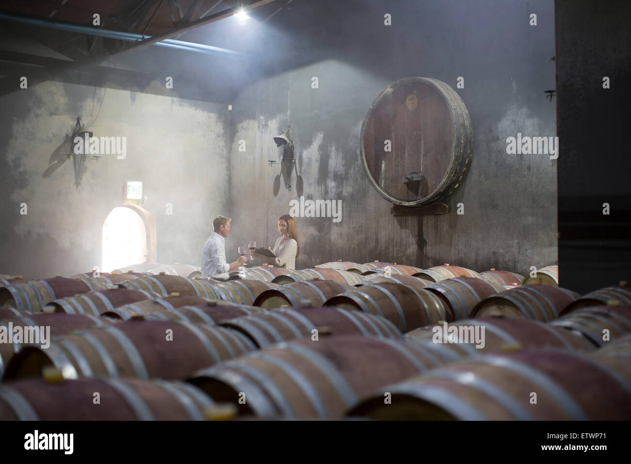 Man and woman tasting wine in cellar Stock Photo - Alamy