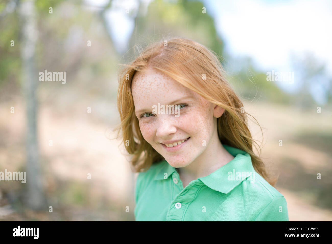 Portrait of smiling girl with red hair and freckles Stock Photo - Alamy