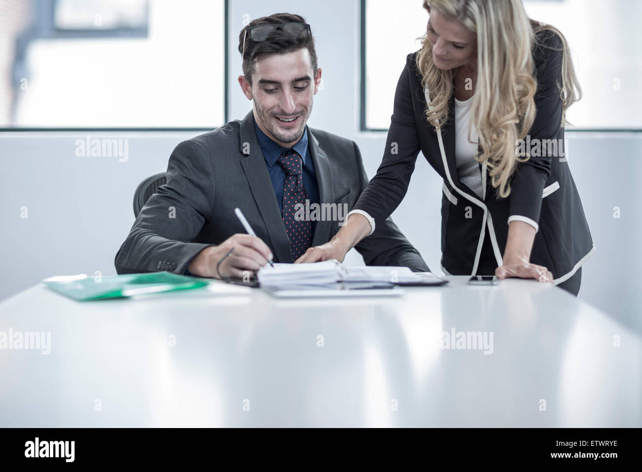 Businessman and businesswoman having an office meeting Stock Photo - Alamy