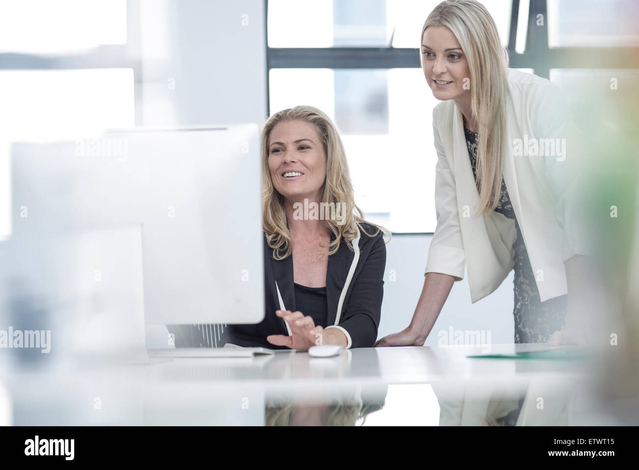 Two businesswomen in office working together Stock Photo - Alamy