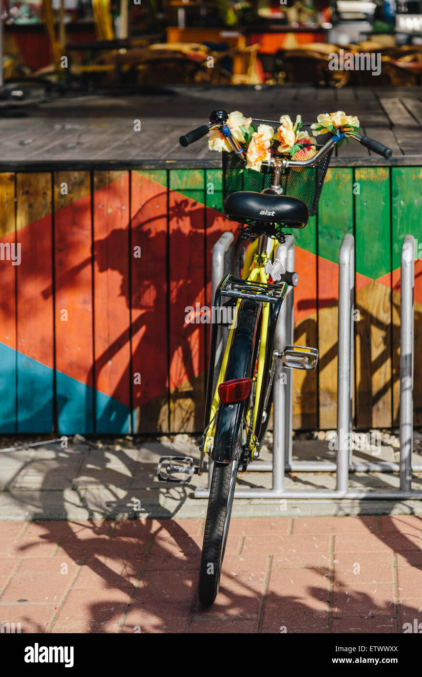 Bicycle decorated with flowers, parked at Egle outdoor cafe, Kalku Iela (street0, Riga Old Town, Latvia Stock Photo
