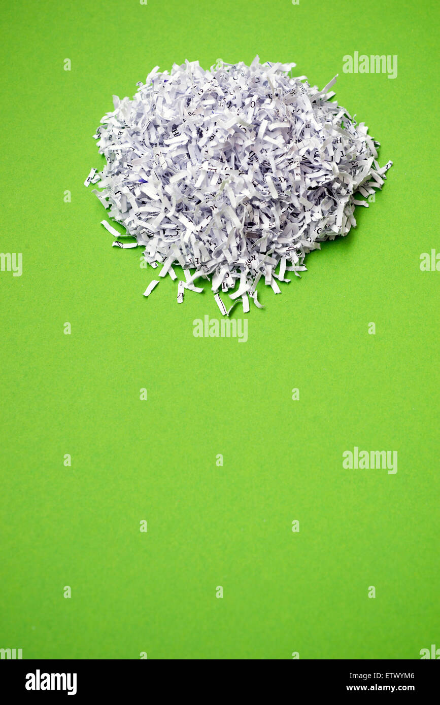 Paper Heap shredded paper heap on the bright green background Stock Photo - Alamy
