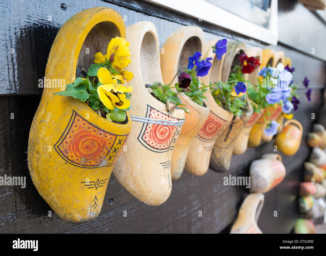 traditional dutch wooden shoes hanging on a wall as decoration Stock Photo