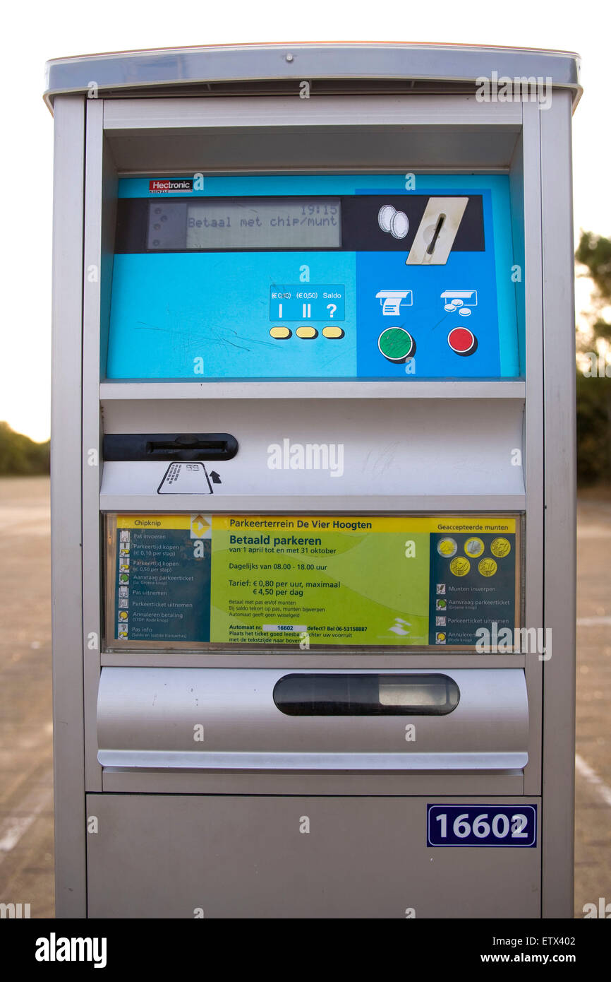 Parkschein Automat (car parking ticket machine) in front of huge mountains  in Tirol, Austria. Travelling in Europe with a car and looking for a  parking lot. The environment is beautiful. Nature Stock