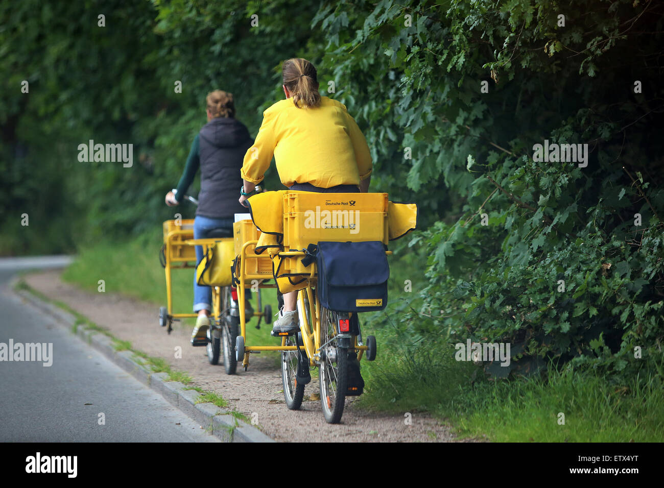 Go Hamburg, Germany, postman of Deutsche Post AG on their bicycles Stock Photo