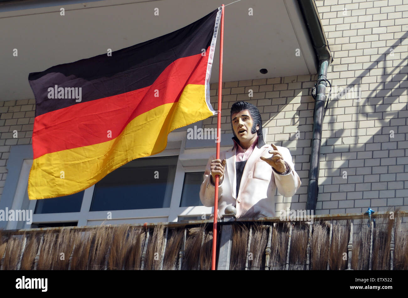 Westerland, Germany, Elvis Presley figure and the Germany flag Stock Photo