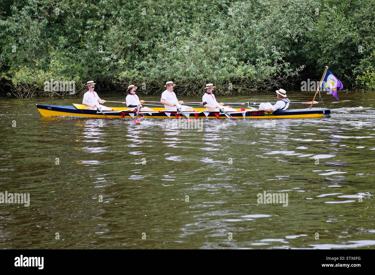 On the River Thames at Runnymede, Sooty a scull crewed by mustached rowers works its way upstream Stock Photo
