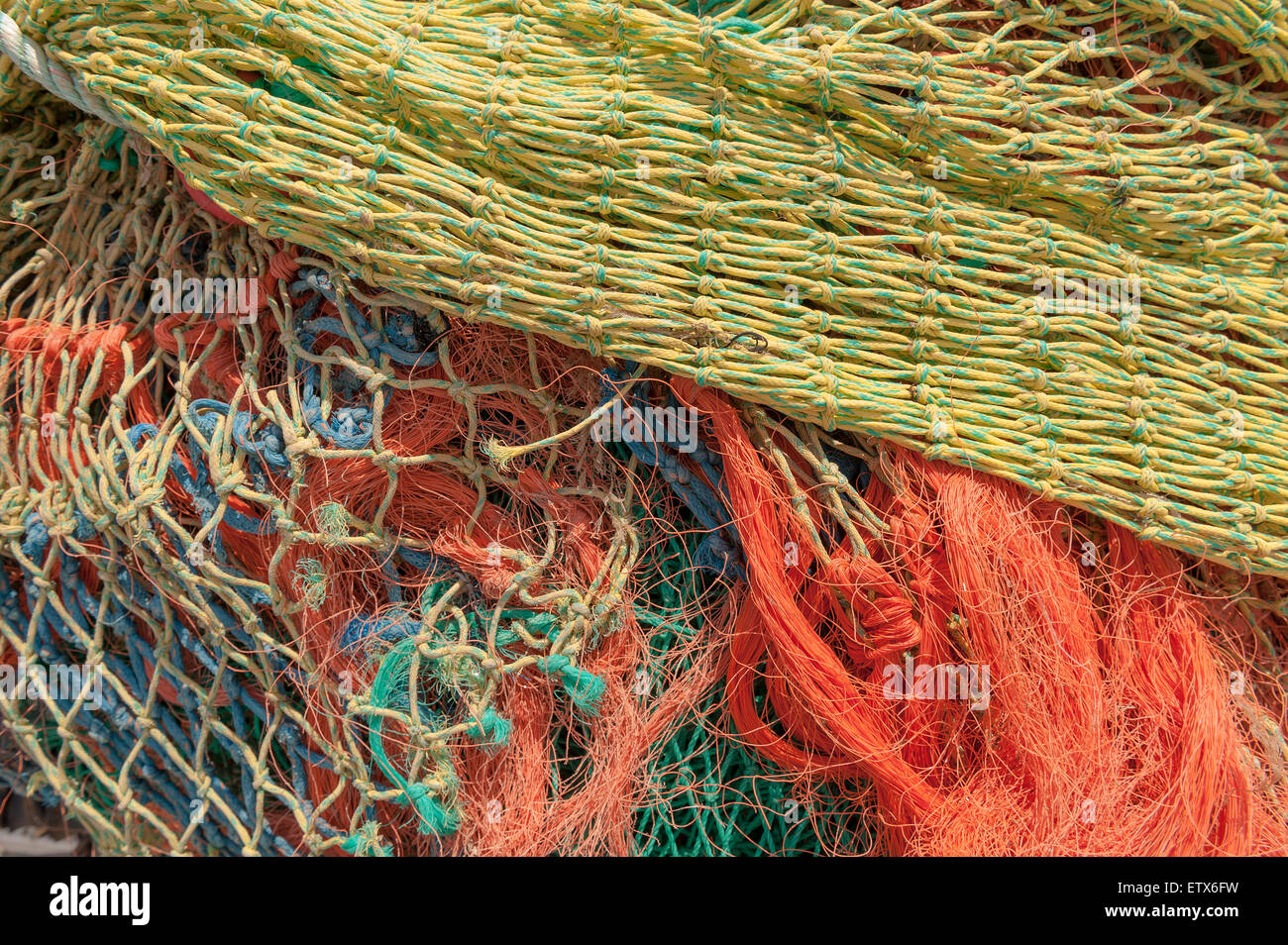 Mass of dry weathered fishing nets with mesh of different sizes a