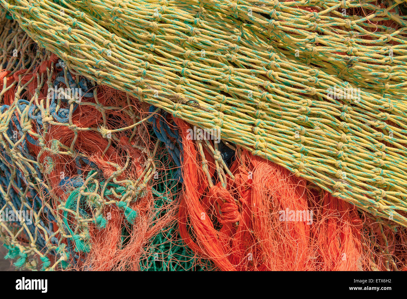 Mass of dry weathered fishing nets with mesh of different sizes a mixture of old and new nylon