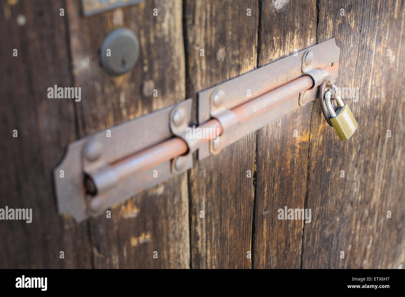 Old latch of a wooden door of a cow shed Stock Photo