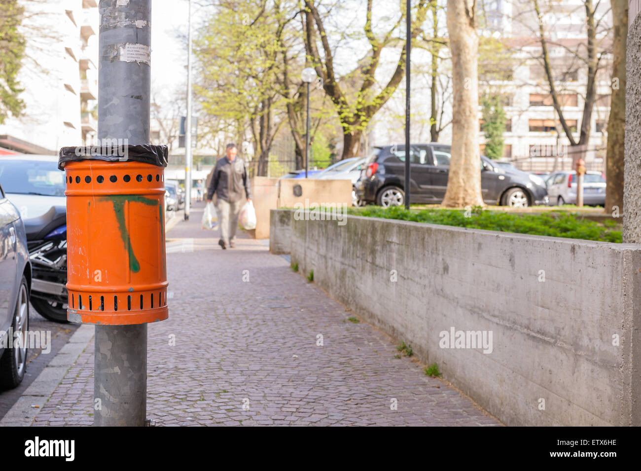 Trash orange metal for the collection of waste of the road Stock Photo