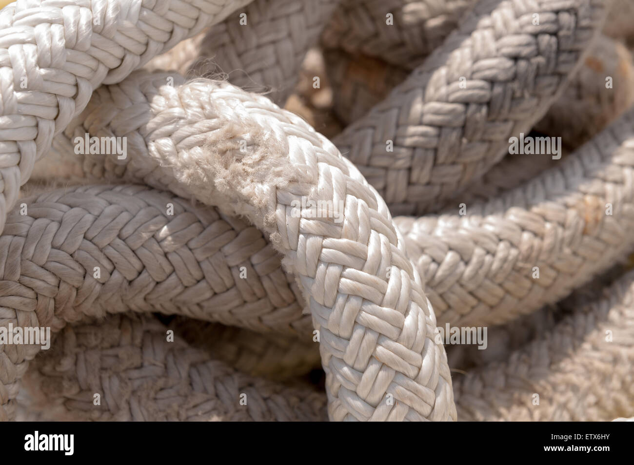 coiled woven strong rope secure and slightly frayed smaller fibers on  surface of weave pattern Stock Photo - Alamy