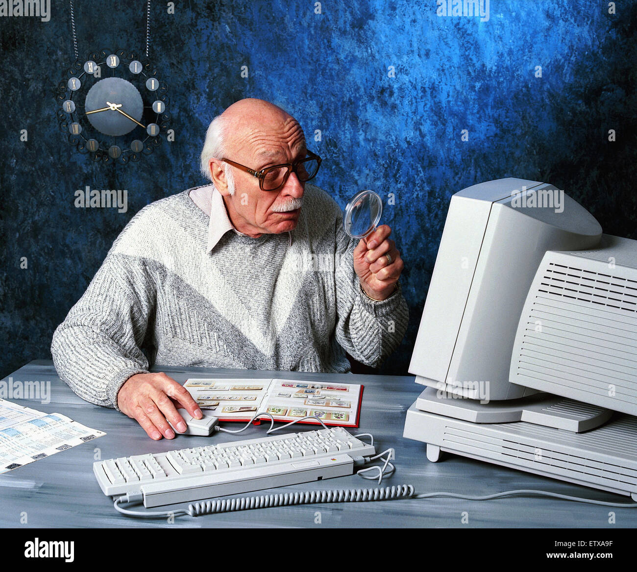 Hamburg, Germany, elderly man with a magnifying glass looking at a computer  Stock Photo - Alamy