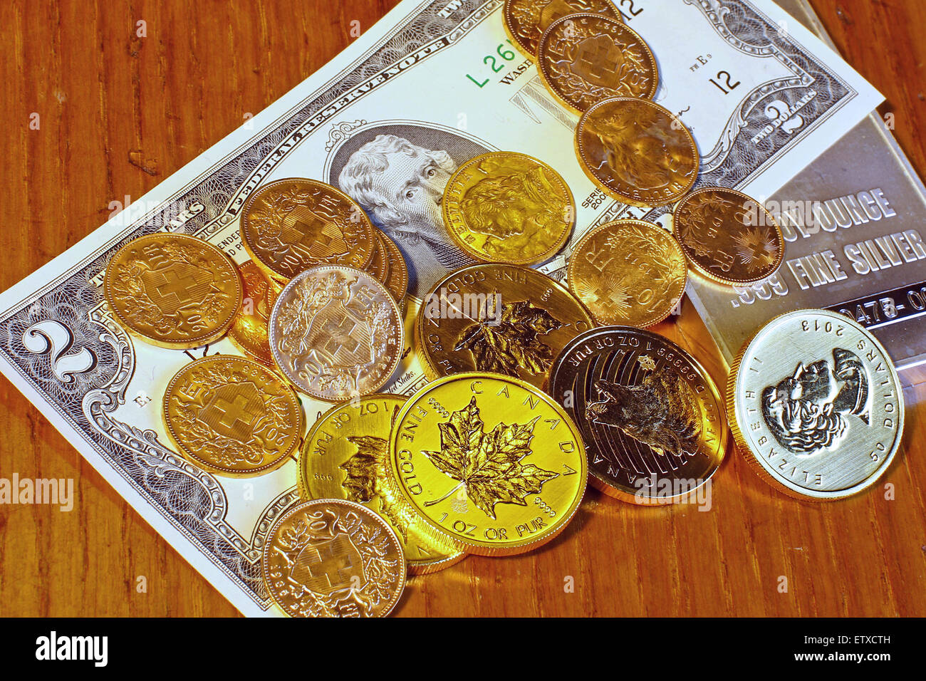Savings over time gold vs paper currency concept Stock Photo