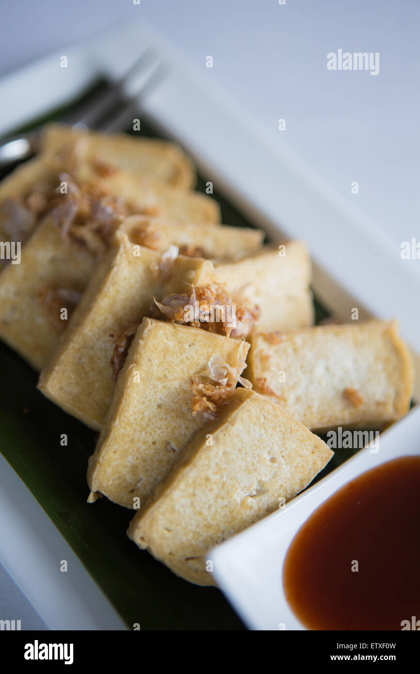 Fried tofu with crispy garlic garnish & soy sauce Stock Photo - Alamy