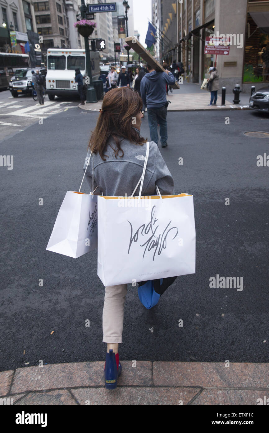 woman loaded with shopping from lord taylor in midtown manhattan on ETXF1C